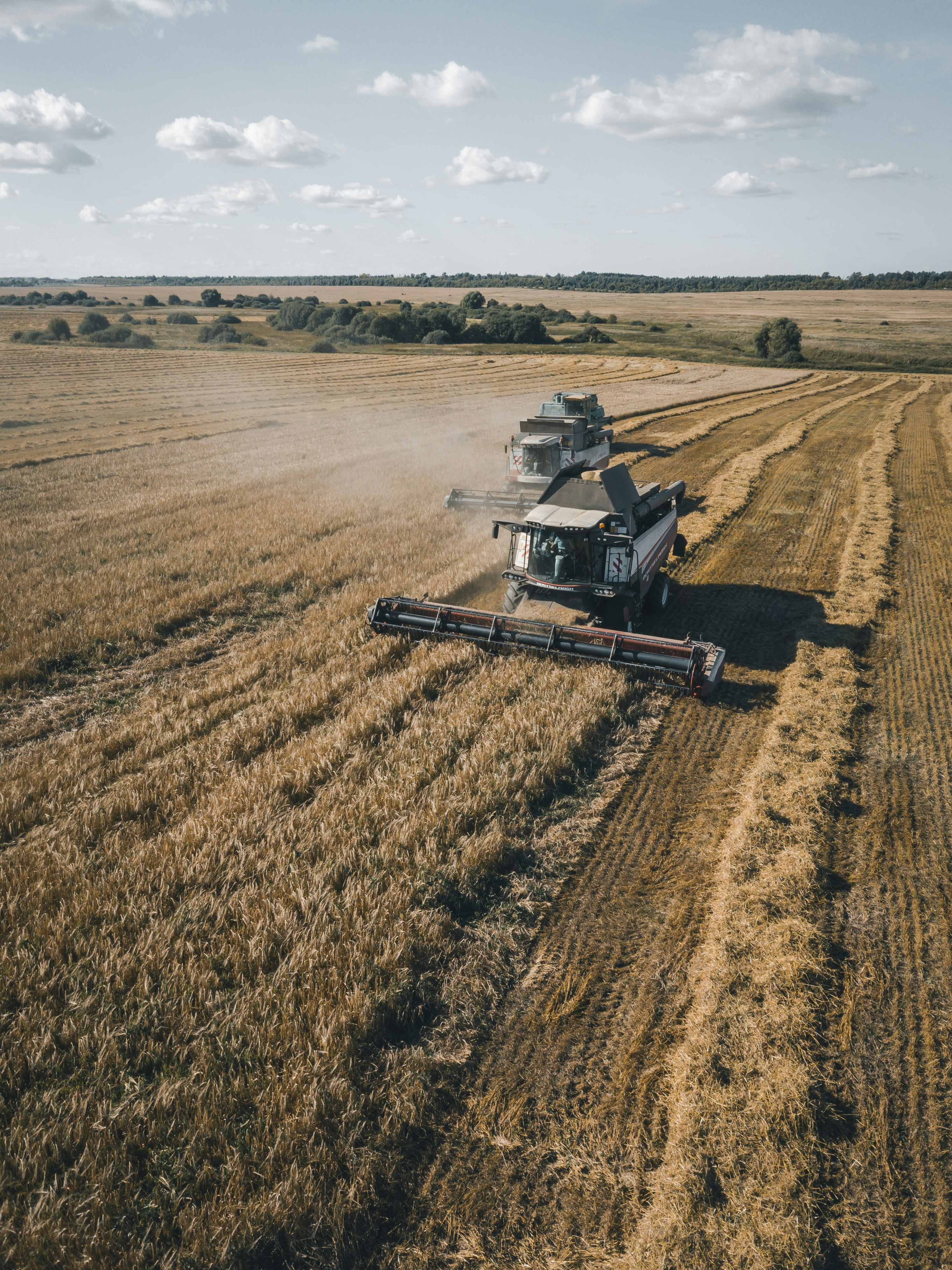 brown and black heavy equipment on brown field during daytime